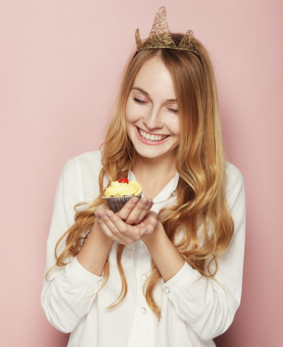 Birthday ideas for your blog - woman holding birthday muffin