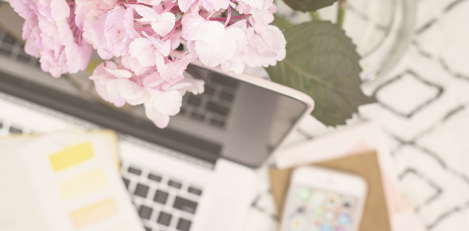 Pink hydrangea with a blurry laptop in the background