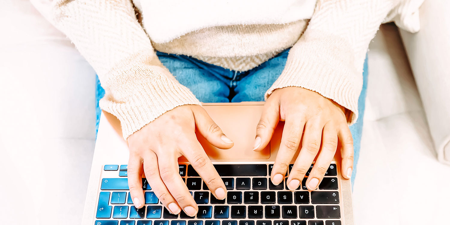 Woman typing on keyboard